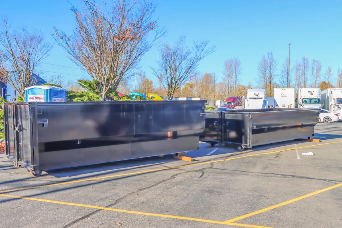 Professional dumpster rental service with roll-off container on residential driveway in Lompoc